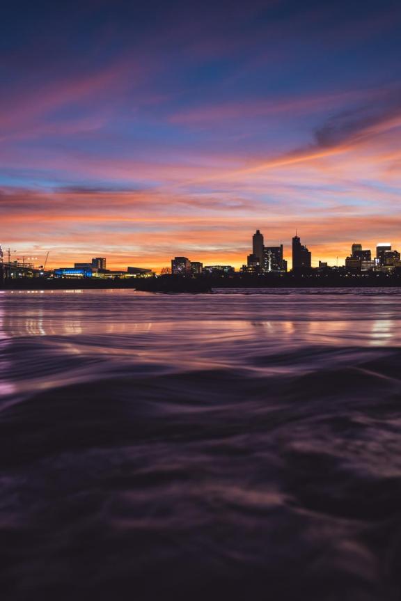Hernando de Soto bridge over the Mississippi River at sunset with the Memphis Skyline in the background.