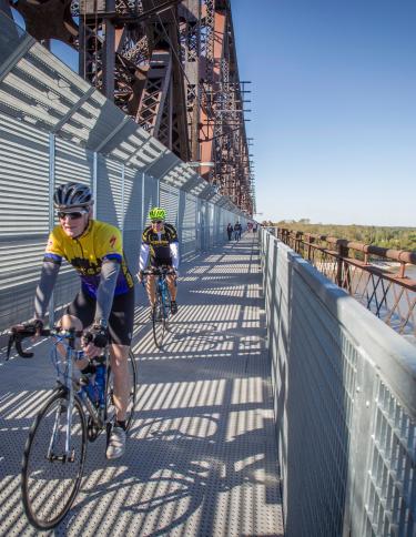 Bikers going across Big River Crossing