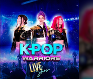 KPOP Warriors promotional artwork featuring three costumed performers with colorful hair on a bright blue stage, with the KPOP Warriors logo displayed prominently in front.