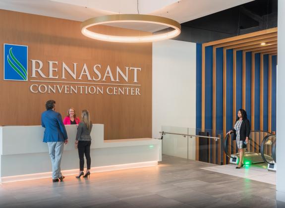lobby entrance at RCC. woman greets two people at the front desk